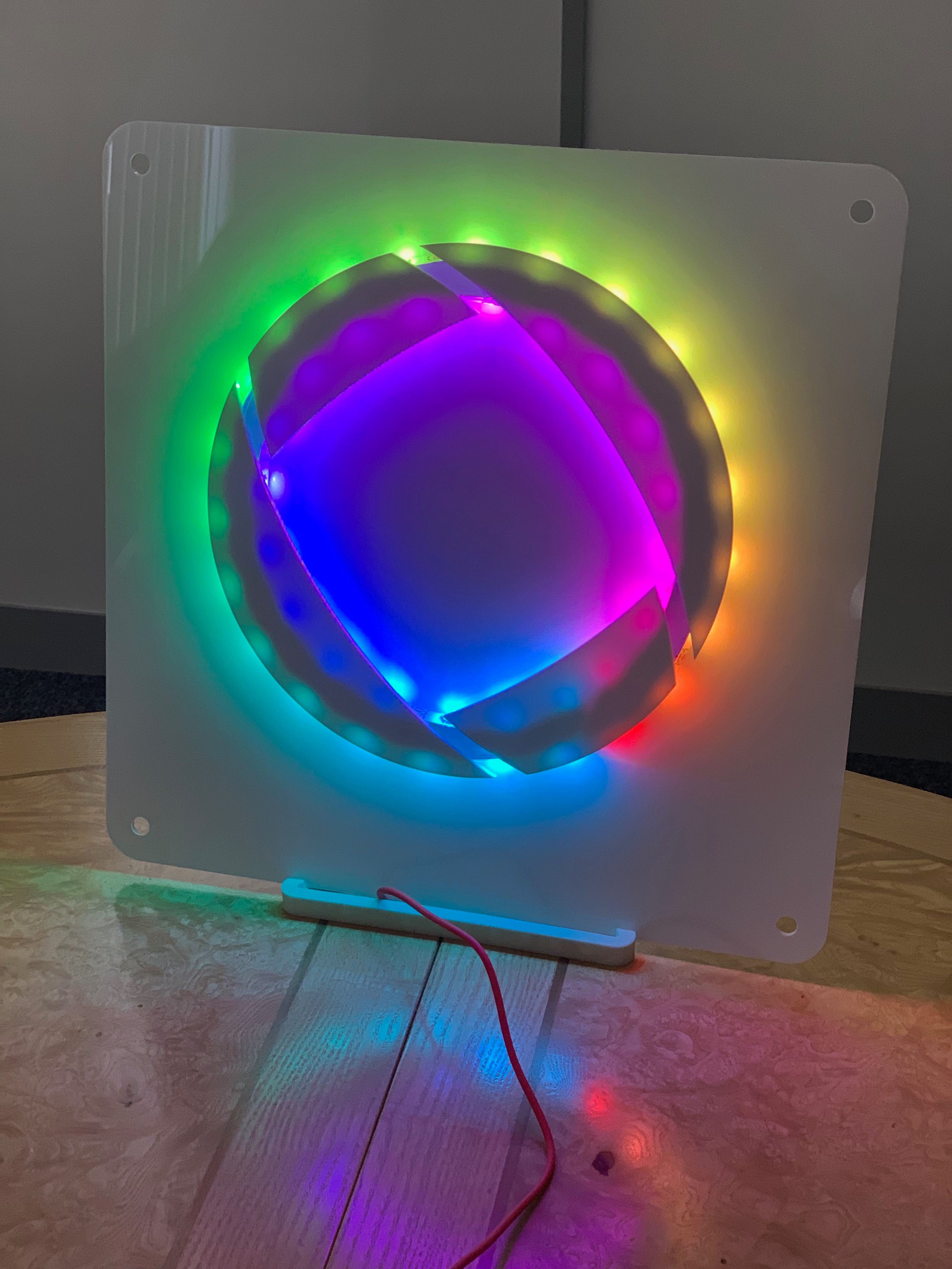 Colourful Osirium ribbons Osirium logo lit up in different colours using NeoPixels